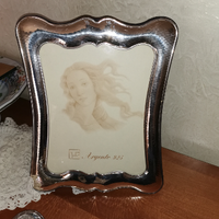 Cornice e quadri in argento