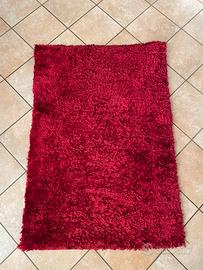 Tappeto shaggy a pelo lungo di colore rosso,
