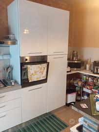 cucina con tavolo, sedie e vetrinetta..