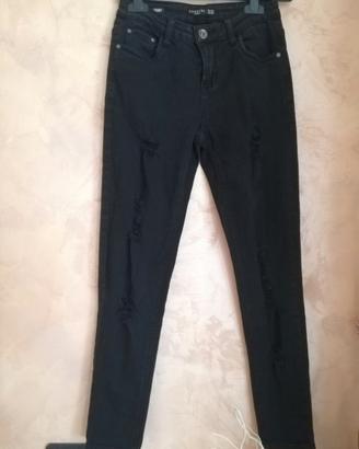 Jeans skinny nero donna con effetto strappato.