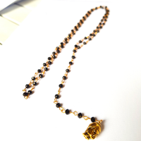 Rosario in oro e particolare ottone