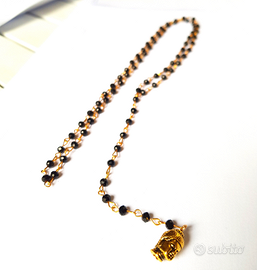 Rosario in oro e particolare ottone