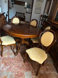 Tavolo rotondo con sei sedie, elegante e raffinato