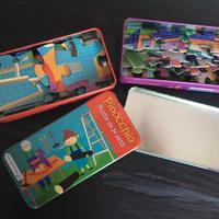 Due puzzle “The purple cow”  in scatolette metallo