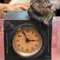 Scultura orologio Cacciabuoti