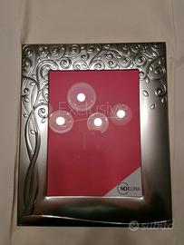 Cornice con decorazione in argento