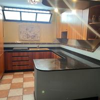 Cucina in ciliegio e granito con elettrodomestici