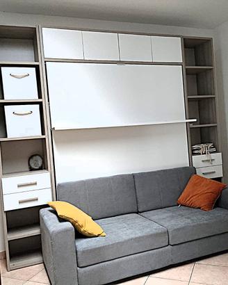camera con letto a scomparsa e divano