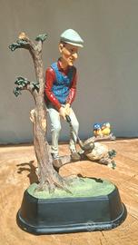 statuetta  di golfista in una posa umoristica,