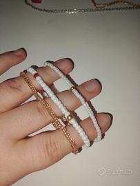 3 bracciali bianco e oro
