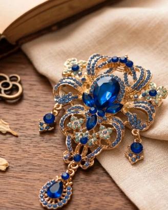 Spilla gioiello blu reale e oro con pendente