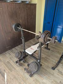 Panca, due bilancieri, 6 manubri e 166 kg di ghisa