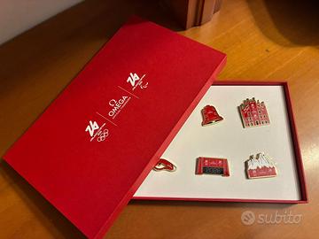 Set di sette spille omega con scatola