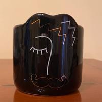 Candela con viso di uomo