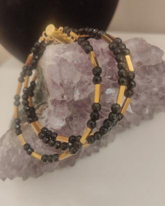 bracciale tre fili cristalli e acciaio nero e oro