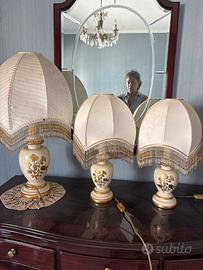 Tre lampade in ceramica avorio e oro, firmate