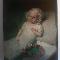 ritratto di neonato con corona di rose