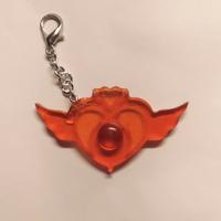 Portachiavi arancione Sailor Moon in resina.