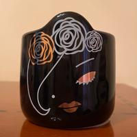 Candela con viso di donna